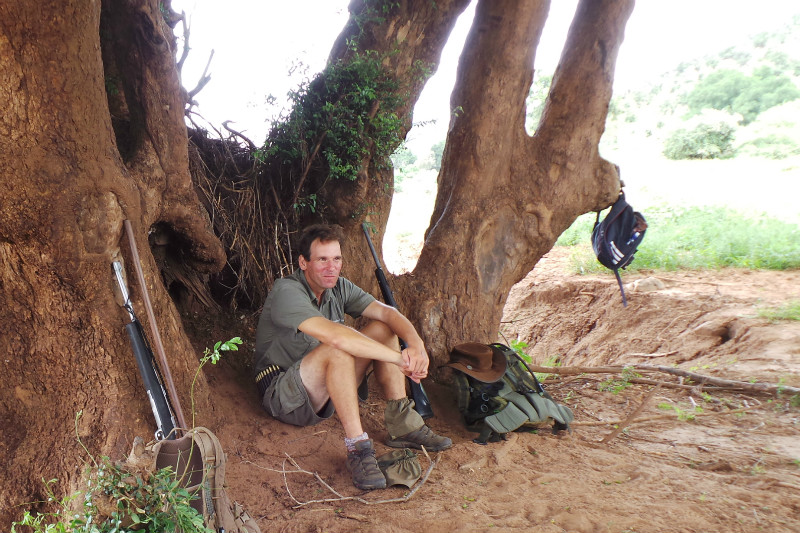 James Bailey rests under a nyala tree during a five hour walking safari